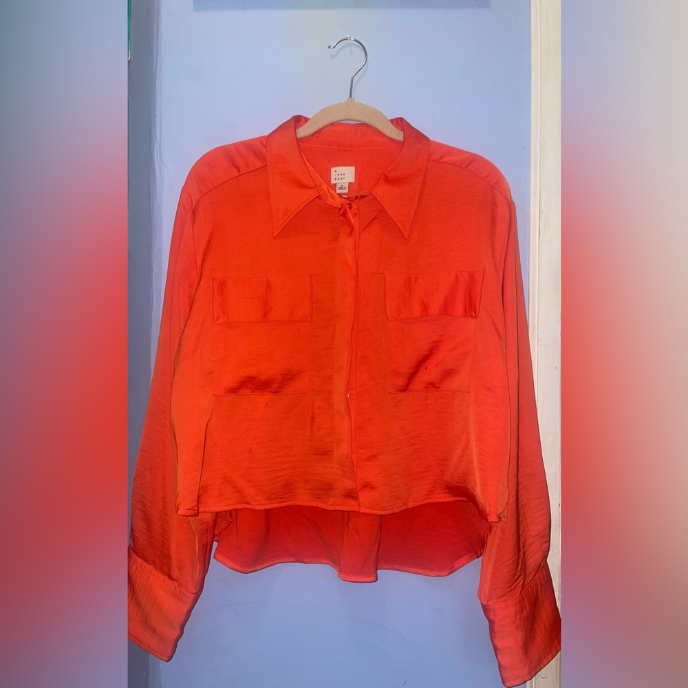 Bright orange long sleeve button up top